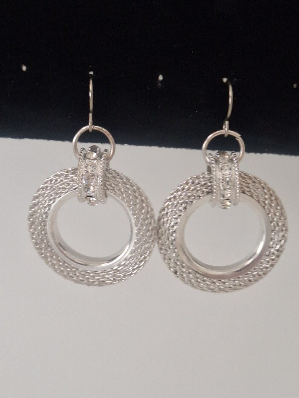 Silver tone earrings with rhinestone accents